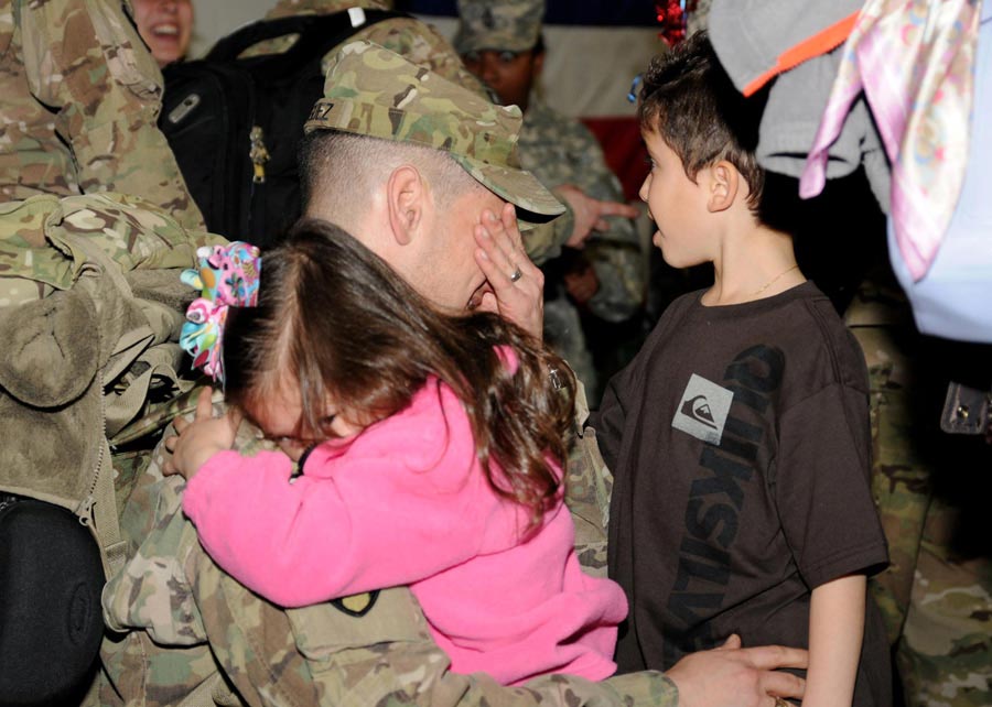Soldiers from XVIII Airborne Corps, are greeted by family and friends as they return from year-long deployment