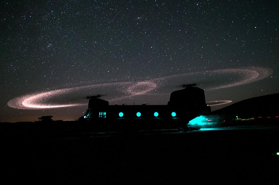 Dust lights up rotors of CH-47 Chinook helicopter as paratroopers with 3rd Squadron, load for an air assault mission