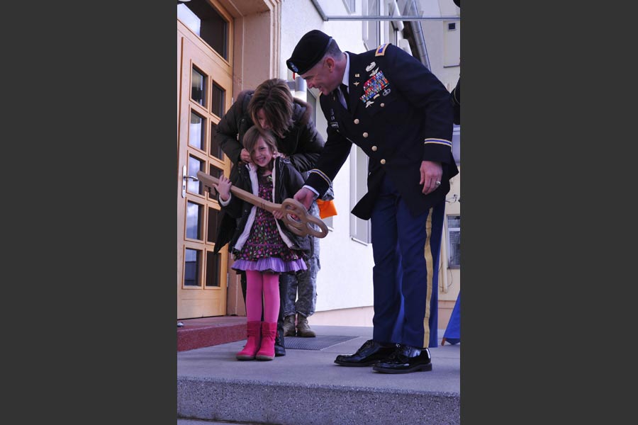Daughter of fallen aviator Chief Warrant Officer 5 John C. Pratt, Emma Pratt, shows key to newly named Pratt Headquarters