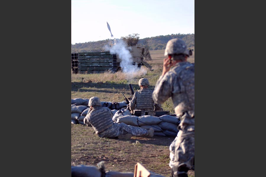 Mortar men with 2nd Infantry, launch mortar during combined-arms field training exercise