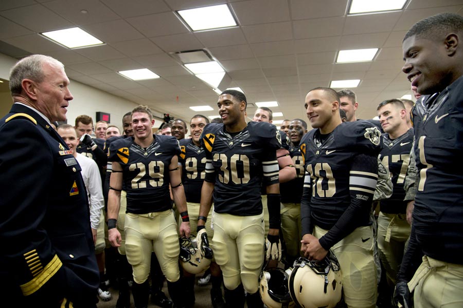 General Martin E. Dempsey, chairman of the joint chiefs of staff, speaks with West Point cadet football players