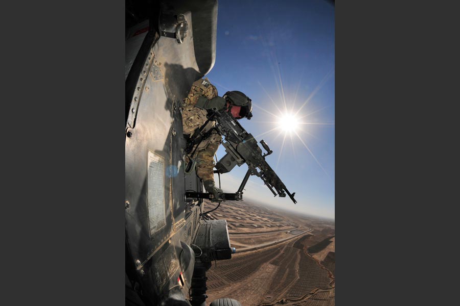 Specialist Richard Burton, with 25th Infantry Division, provides security in Black Hawk helicopter over Afghanistan's Kandahar province