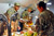 Captain Jefferson Mason, left, serves Thanksgiving dinner to a Soldier on Joint Combat Outpost Mushan, Afghanistan