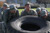 Soldiers trying to lift over-sized truck tire