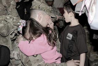 Soldiers from XVIII Airborne Corps, are greeted by family and friends as they return from year-long deployment