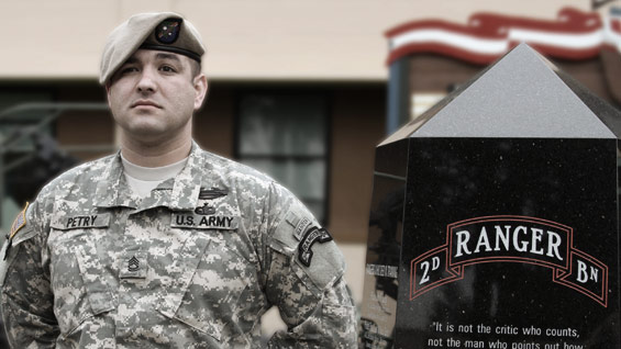 Sergeant First Class Petry standing with Ranger Scroll in background