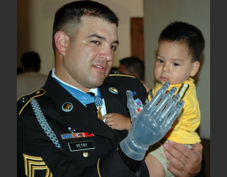 Sergeant First Class Leroy A. Petry, Medal of Honor recipient, 75th Ranger Regiment, poses for a picture with a friend’s child after his welcome home parade in Santa Fe, New Mexico