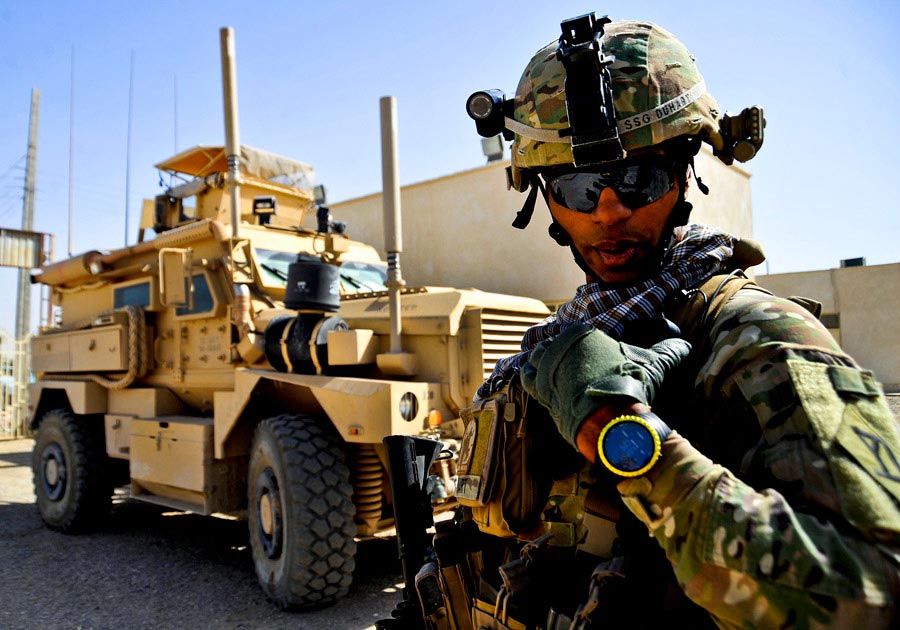 Staff Sergeant David Duhart assesses the security during a mission to a vocational school, Farah City, Farah province, Afghanistan