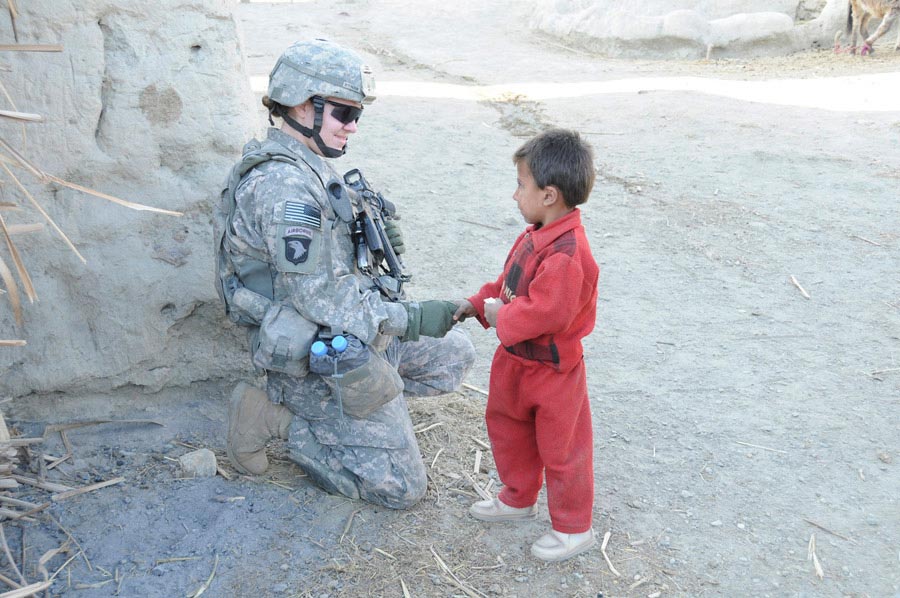 United States Army Soldier saying hello to Afghan child