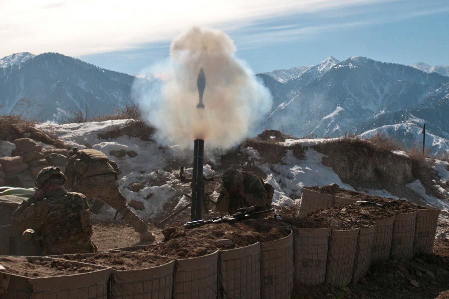 A 120mm mortar round flies out of a tube