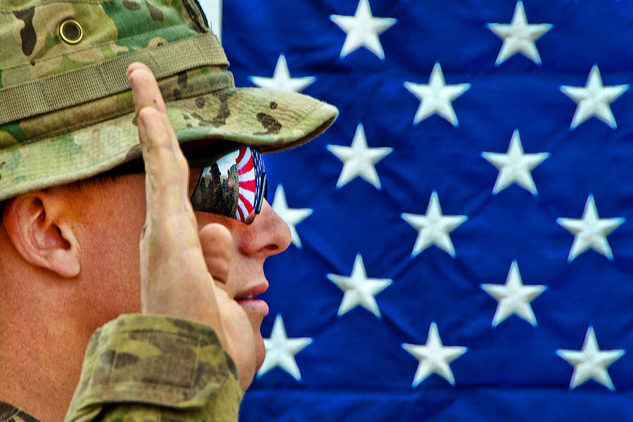 American flag reflects in the glasses of an officer with the 82nd Airborne Division