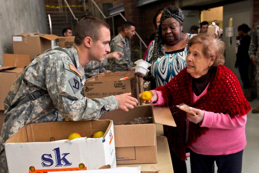 Specialist Anthony Monte, from New Jersey Army National Guard, mobilized for Hurricane Sandy, provide assistance to displaced residents